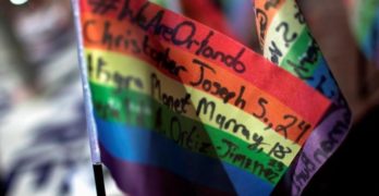 Messages written on rainbow flags are seen placed at a makeshift memorial to remember the victims of the mass shooting at a gay nightclub in Orlando, outside the Stonewall Inn in Manhattan