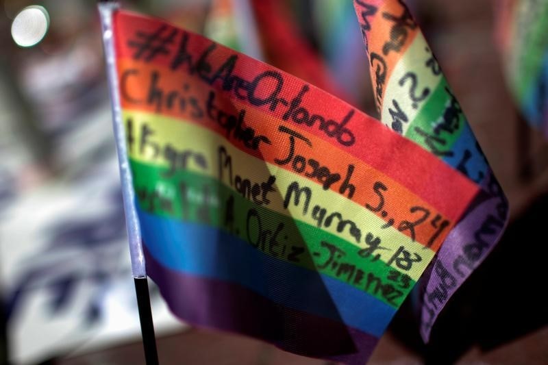 Messages written on rainbow flags are seen placed at a makeshift memorial to remember the victims of the mass shooting at a gay nightclub in Orlando, outside the Stonewall Inn in Manhattan