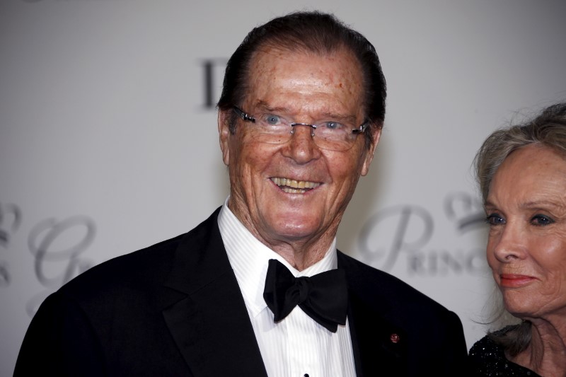 FILE PHOTO: British actor Roger Moore and his wife Kristina Tholstrup arrive at the Princess Grace Awards gala in Monaco