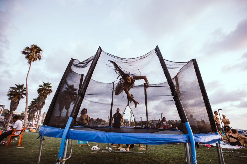 anonymous athlete jumper bouncing on trampoline