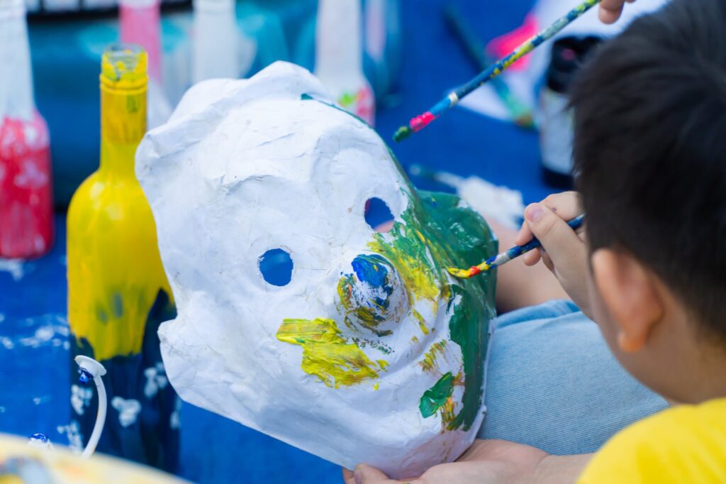 children painting on masks