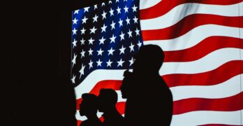 silhouette of four person with flag of united states background