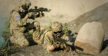 military sniping near rock