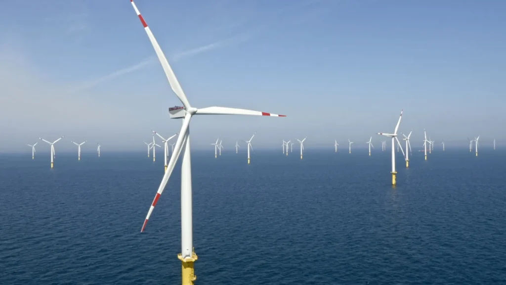 The debate around electric vehicles, windmills, Greenland, Venezuela, oil, and tariffs often appears fragmented, as if each issue exists in its own policy silo. That illusion serves power well. When examined together, these issues reveal a coherent and troubling strategy rooted in protecting entrenched corporate interests—particularly fossil fuels—through coercion, misinformation, and state intervention. The common thread between EVs, … Tariffs on Chinese-made electric vehicles offer the first clue. Classical capitalism argues for efficiency: if another country produces a superior product at lower cost, markets should reward that efficiency. Instead, punitive tariffs block affordable EVs while U.S. automakers scale back production. This is not market correction; it is market distortion. The private sector failed to invest aggressively in EVs when it had the chance, and now the state shields that failure rather than confronting it. That choice delays climate progress and leaves working families paying more for fewer options. The same logic explains the hostility toward wind energy. Offshore wind projects—many led by Danish firms like Ørsted—represent large-scale threats to oil’s dominance. Claims that turbines threaten national security collapse under basic physics and radar science. Modern militaries already distinguish complex signal environments. What truly alarms fossil interests is that wind power reduces dependence on oil, shrinking profits and geopolitical leverage. That fear also clarifies renewed fixation on Greenland. Greenland holds vast reserves of rare earth minerals essential for renewable energy and advanced electronics. Though self-governing under Denmark, Greenland faces external pressure framed as “strategic interest.” This echoes earlier imperial patterns: identify resources, question sovereignty, insert influence. The outrage from Danish and Greenlandic leaders reflects a fundamental truth—resource desire, not defense, drives this attention. Venezuela fits squarely into the same pattern. The country sits atop some of the world’s largest oil reserves and significant mineral wealth. For decades, U.S. policy has punished Venezuela through sanctions, asset seizures, and maritime enforcement, all while claiming humanitarian concern. Yet countries like Norway demonstrate that public stewardship of resources can fund social welfare without economic collapse. Venezuela’s crime, in Washington’s eyes, was asserting sovereignty over its wealth rather than surrendering it to multinational corporations. Oil companies themselves expose the contradiction. Firms like BP once rebranded as forward-looking energy leaders, promising transition. Those campaigns vanished once profits surged. Instead of reinvesting excess earnings into renewables, corporations doubled down on extraction, lobbying governments to block competitors like wind and EVs. This is not capitalism evolving—it is capitalism captured. At the center of these choices stands political leadership that embraces spectacle over strategy. Under Donald Trump, renewable projects halted on whim, tariffs replaced planning, and foreign policy blurred into open resource intimidation. Such instability undermines even the business community, which relies on regulatory certainty to invest and innovate. When policy shifts with personal bias, economies stagnate. The common thread, then, is imperial protectionism: using state power to preserve corporate dominance while denying both citizens and other nations the benefits of technological and economic progress. Tariffs replace industrial policy. Sabotage replaces transition. Coercion replaces diplomacy. Democracy becomes collateral damage. Progressive policy offers a different path—one rooted in public investment, energy democracy, international cooperation, and respect for sovereignty. Markets can function, but only when they serve people rather than empires. The future economy—clean, distributed, and equitable—will not emerge from fear-driven policy. It will emerge when voters demand leadership willing to break from extraction and embrace transition.